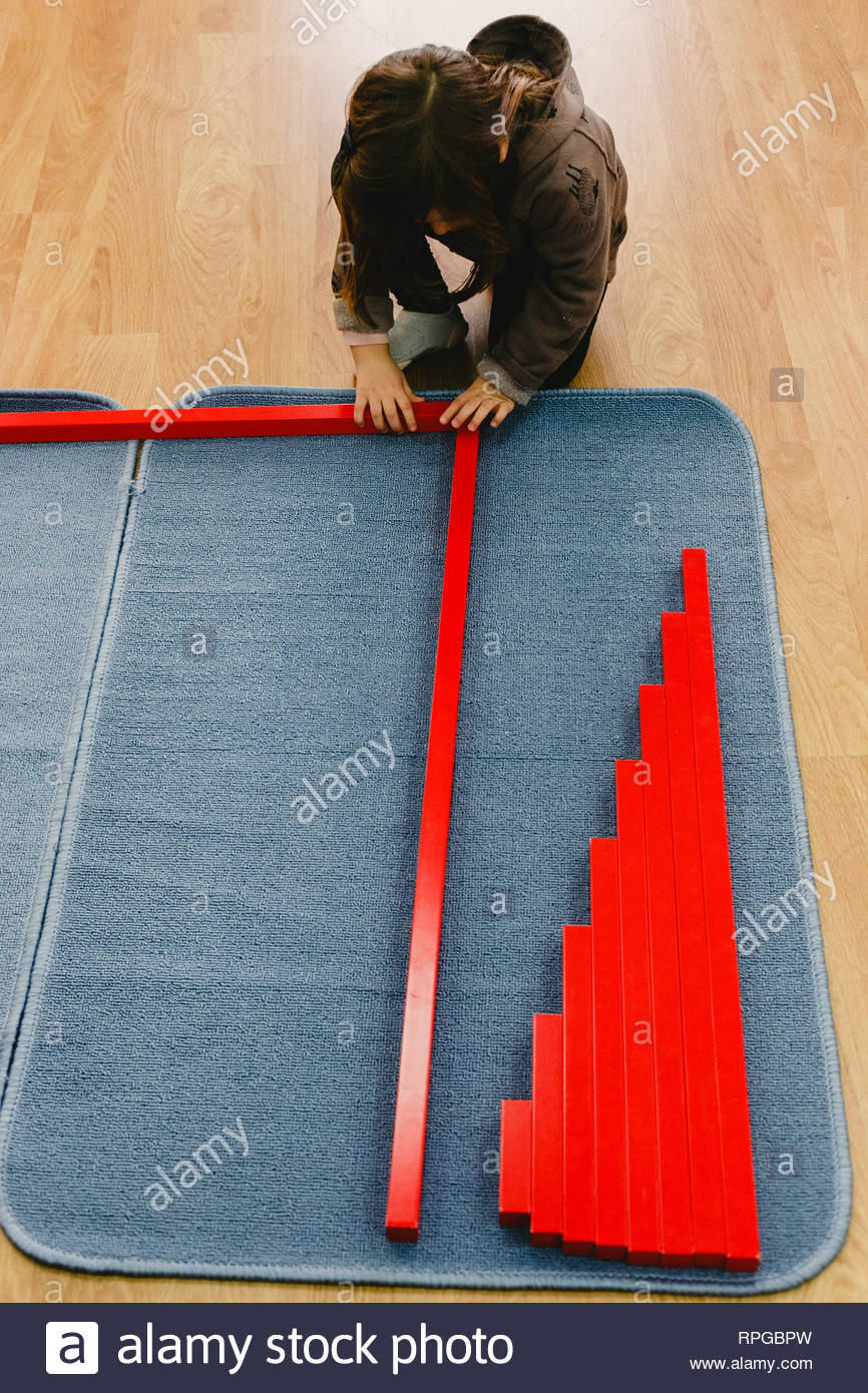 Girl Is A Class Of A School Placing The Red Bars Montessori On A