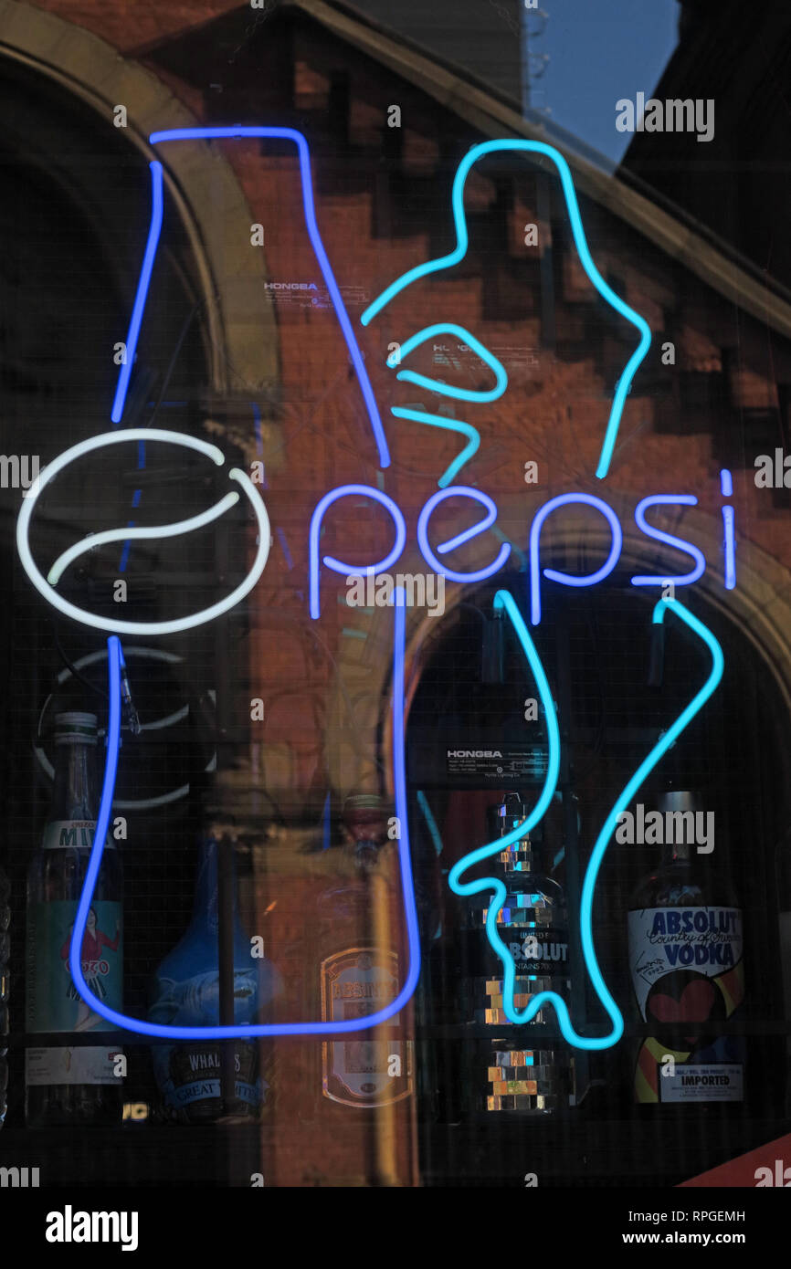 Sexist Pepsi Bottle & female form on a neon sign, sexism alive and well, high heels, long legs, large breasts and a Coke Stock Photo