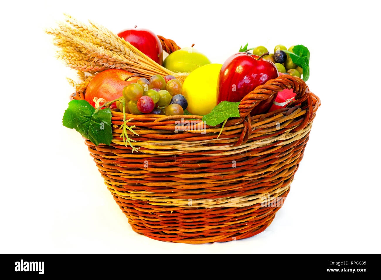 Rattan basket full of fresh organic fruits Stock Photo - Alamy