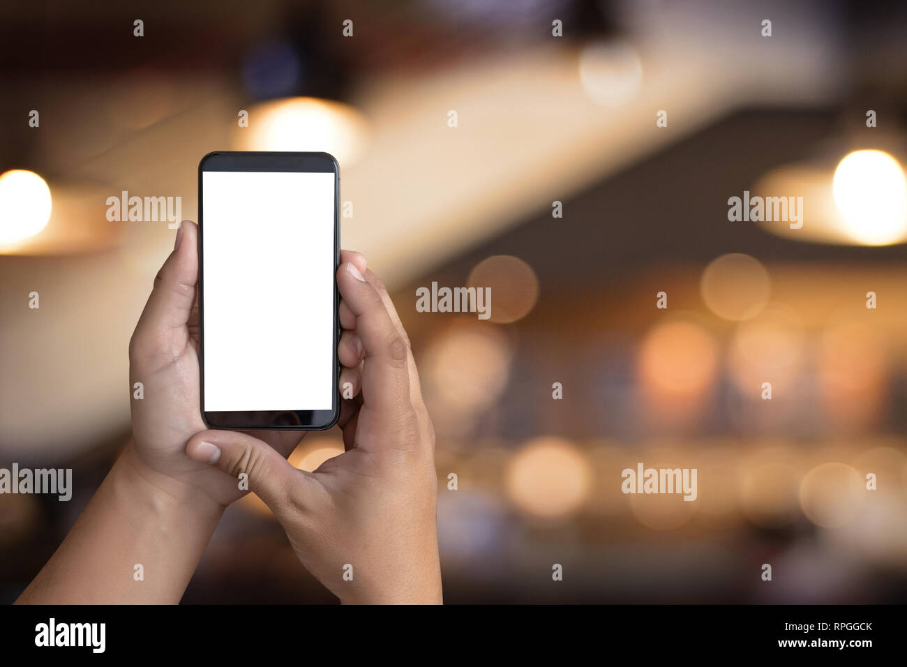 Man hand holding the black smartphone screen mockup Stock Photo