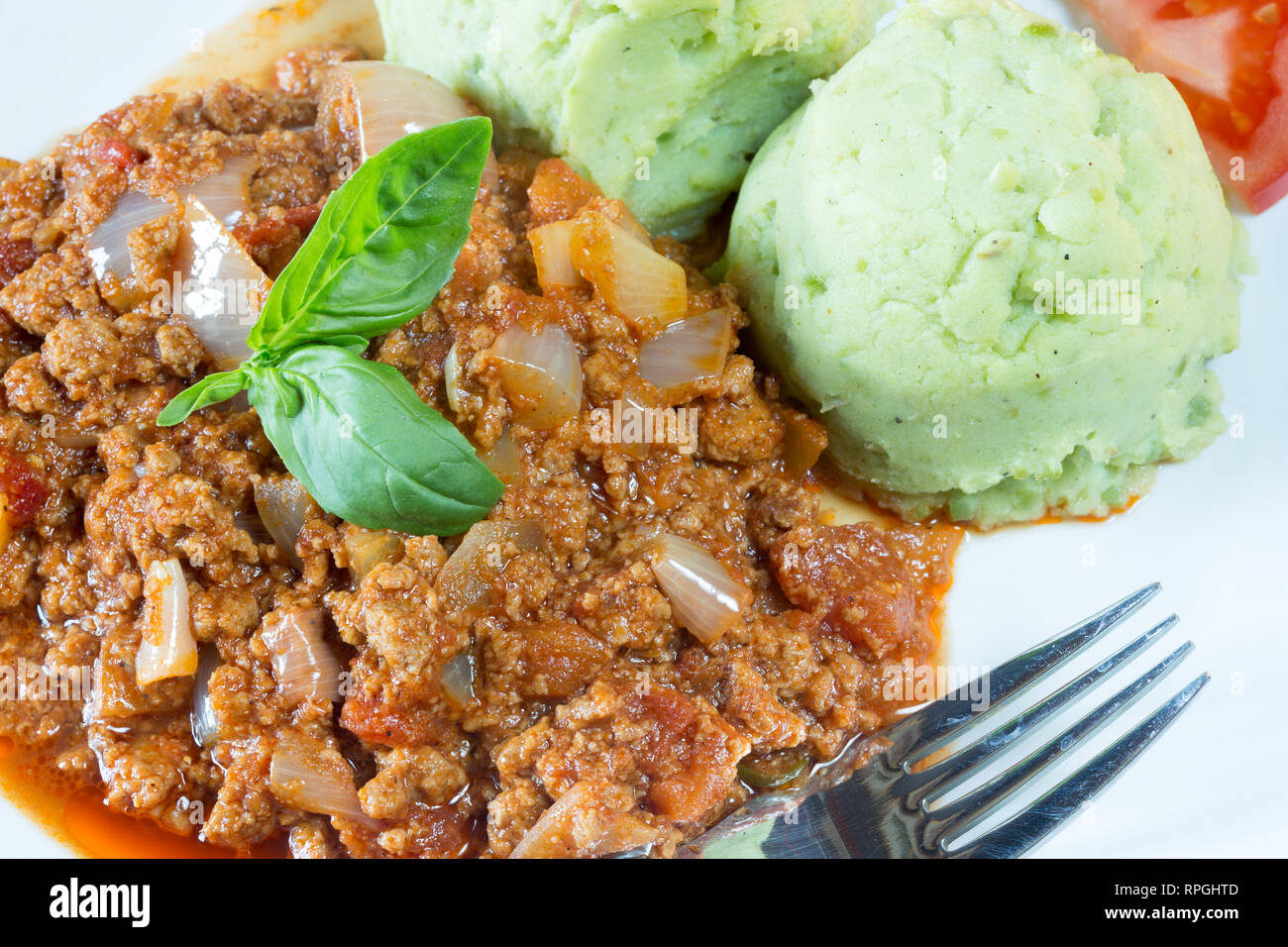 Kenyan curried stew with a side of mukimo. Stock Photo