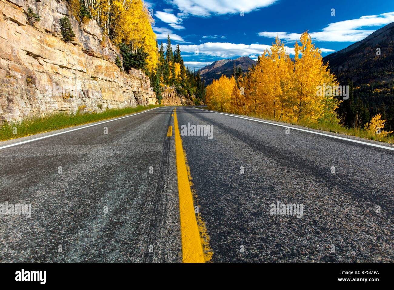 Autumn road with yellow line goes from Ouray to Silverton Colorado, the