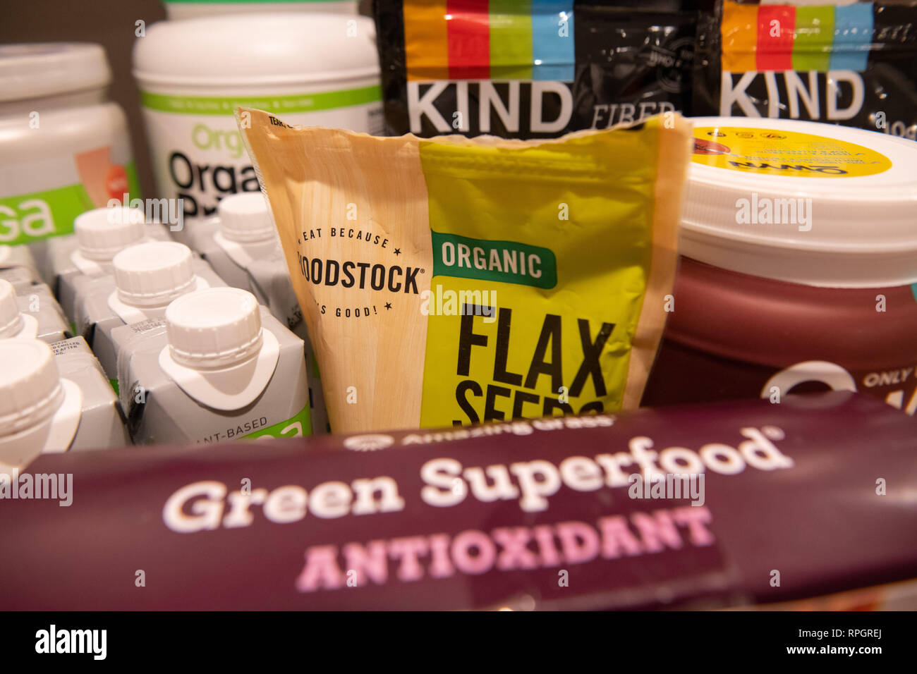 Vegan products / vegetarian superfood products on a shelf / plant-based protein - flax - meal-replacement shakes - Kind grain granola  and nut bars Stock Photo
