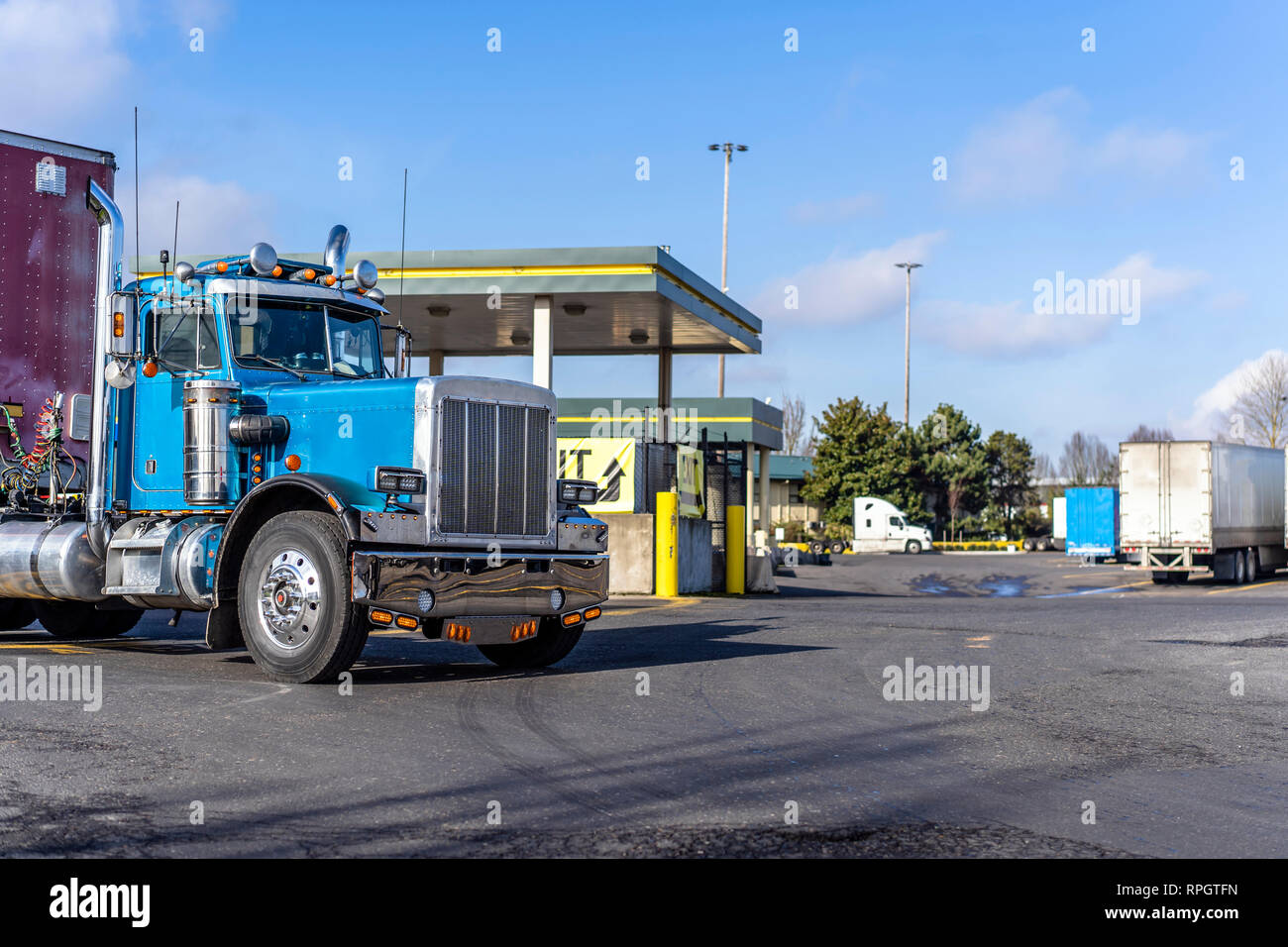 Shiny blue classic American bonnet day cab big rig semi truck with lot of  chrome accessories with dry van semi trailer for transportation commercial  c Stock Photo - Alamy