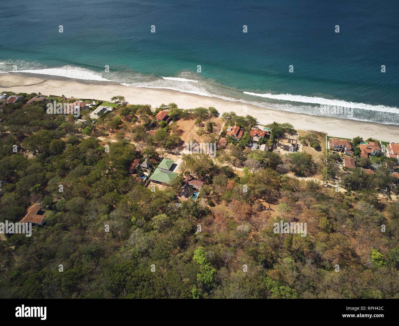 Beachfront property theme. Houses next to beach line aerial drone view Stock Photo