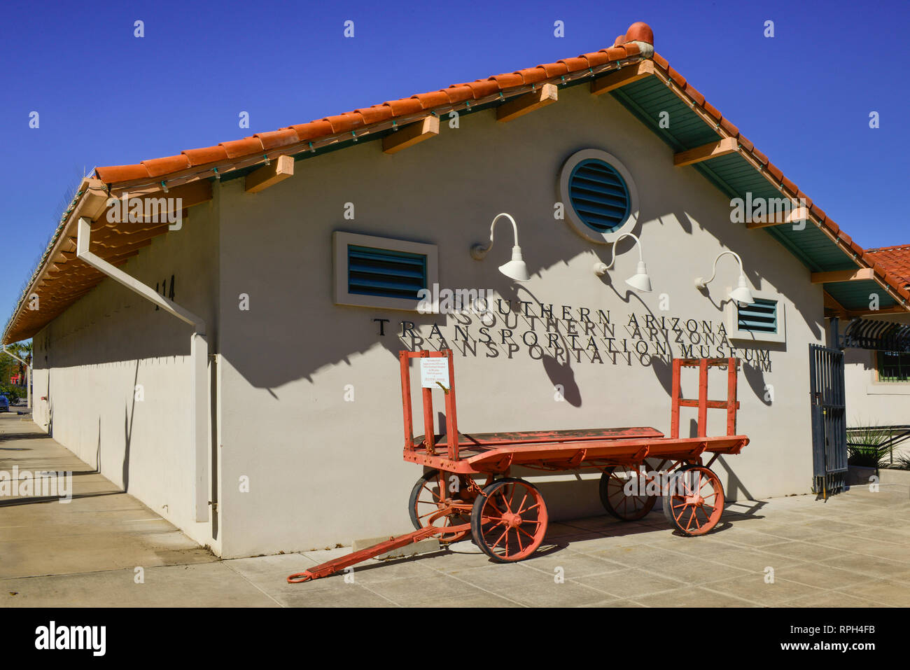 A vintage luggage cart from the 1920's parks in front of the Southern Arizona Transportation Museum building, formerly part of the train depot complex Stock Photo