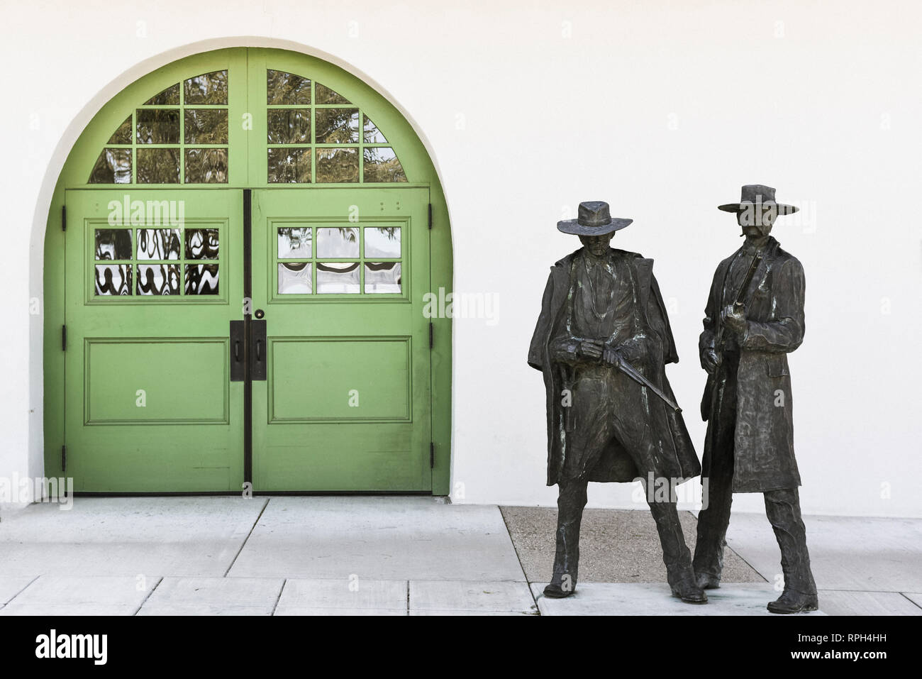 Bronze statues of Doc Holiday and Wyatt Earp commemorating the shooting of Frank Stilwell, near the former Tuscon railroad depot, now a Museum Stock Photo