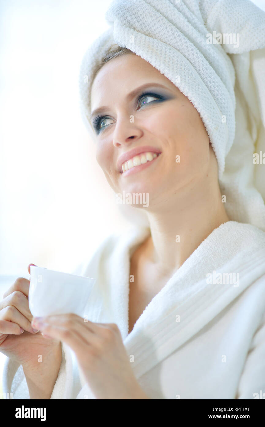 Beautiful young woman after shower with cup of tea Stock Photo Alamy