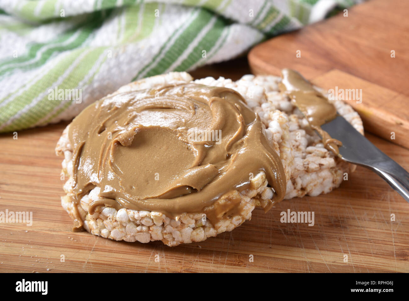 Brown puffed rice cakes with creamy peanut butter Stock Photo Alamy