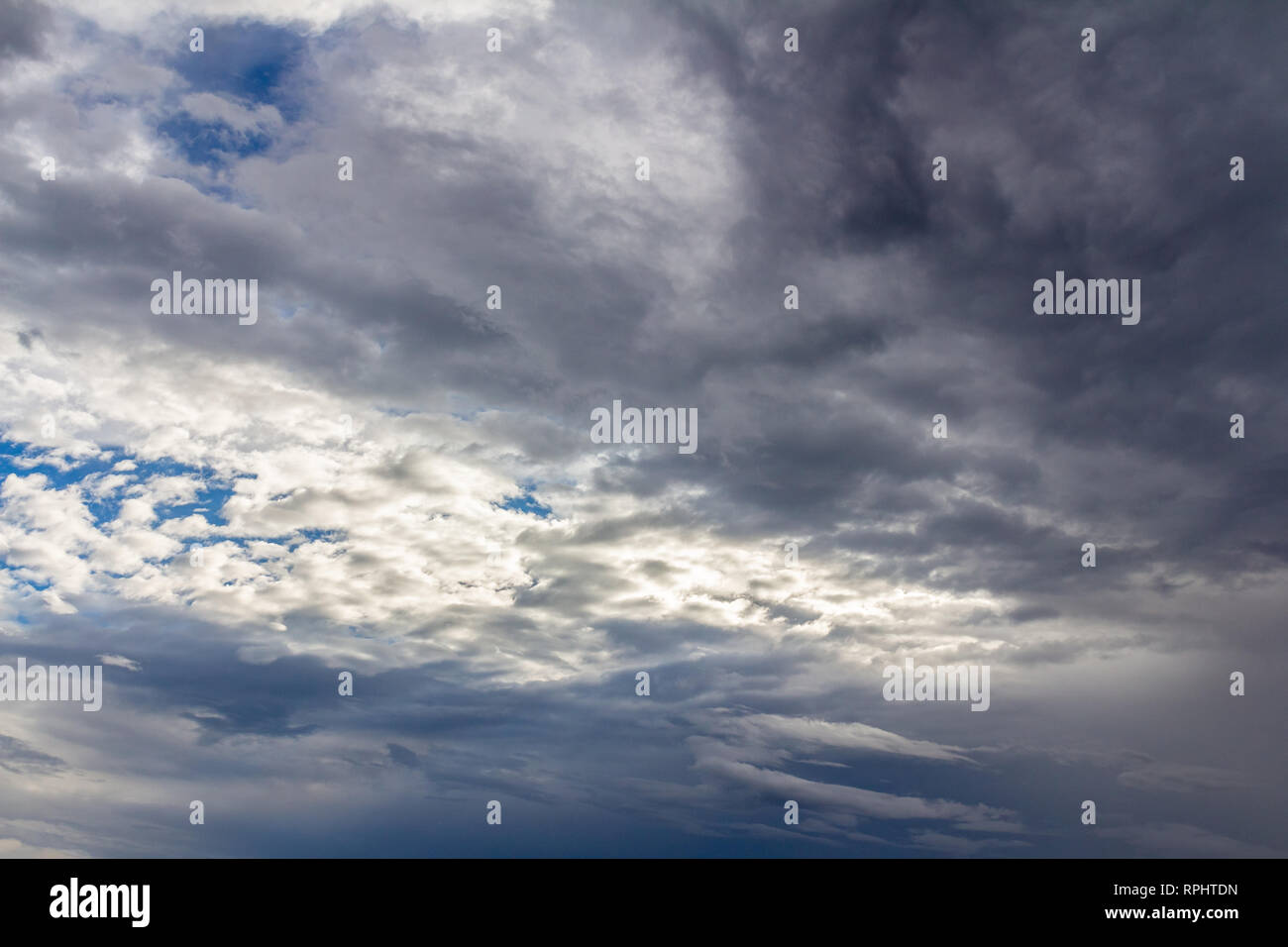 Dark blue stormy cloudy sky natural photo background Stock Photo - Alamy