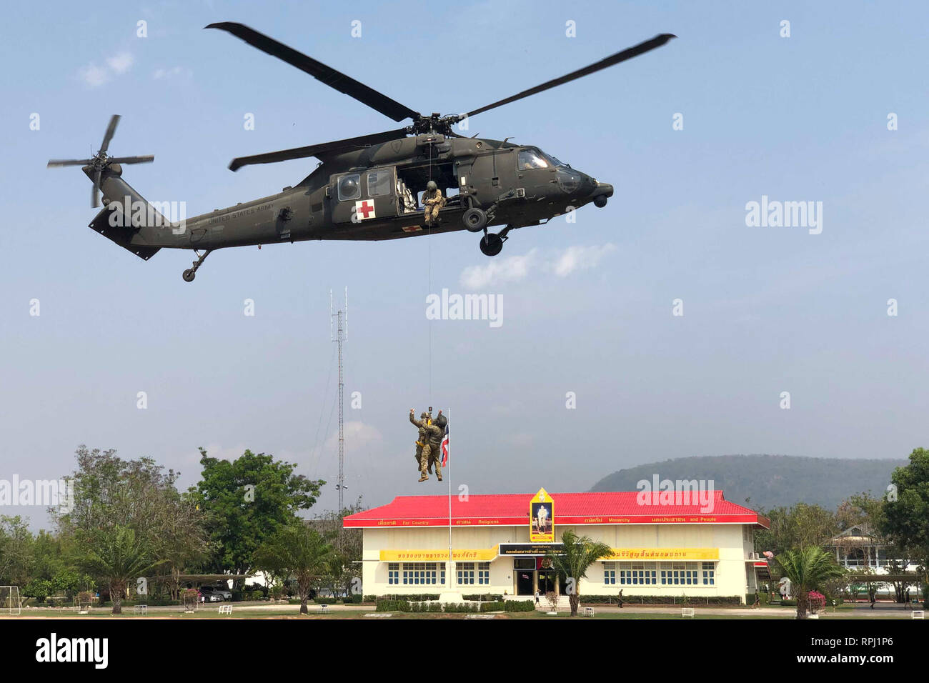 Soldiers with 2nd Battalion, 25th Aviation Regiment, and 1-2 Stryker Brigade Combat Team conduct hoist training at Phitsanulok Province, Thailand, Feb. 17, 2019. This was during Cobra Gold, an exercise designed to advance regional security and ensure effective responses to crises by bringing together a robust multinational force with shared goals and security commitments. (Photo courtesy of U.S. Army) Stock Photo