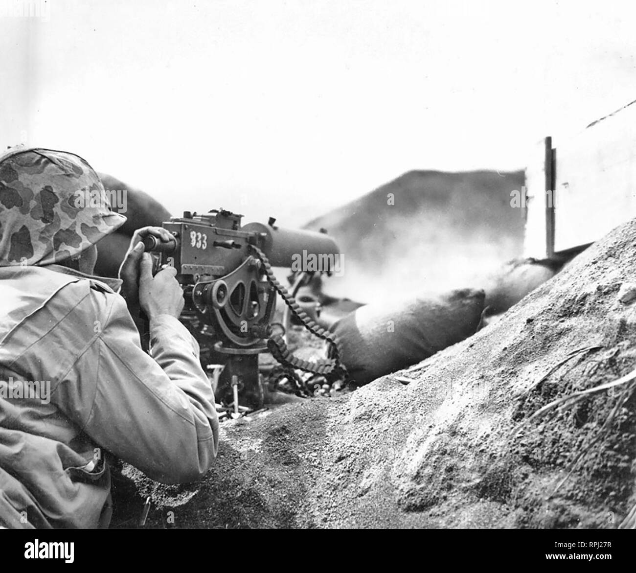 World War II, Iwo Jima - Marine Machine Gun Team Fires on Japanese Positions - HMG Browning M1917 Stock Photo