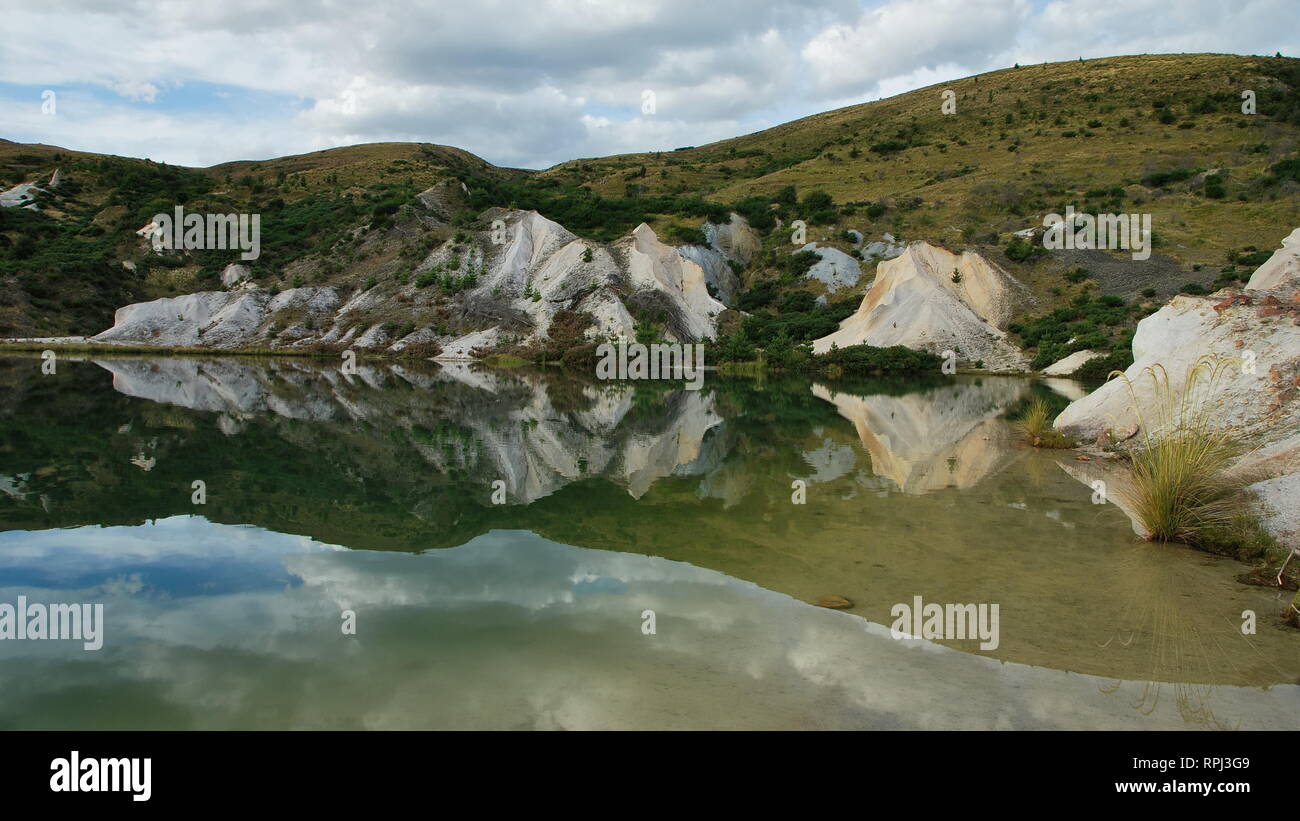 Mirror reflection in the lake at an old gold mine at Saint Bathans. Central Otago, New Zealand. Stock Photo