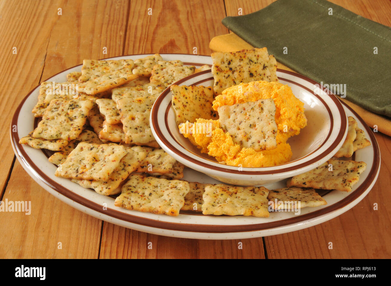 A snack plate of Italian herb flatbread crackers and cheddar cheese