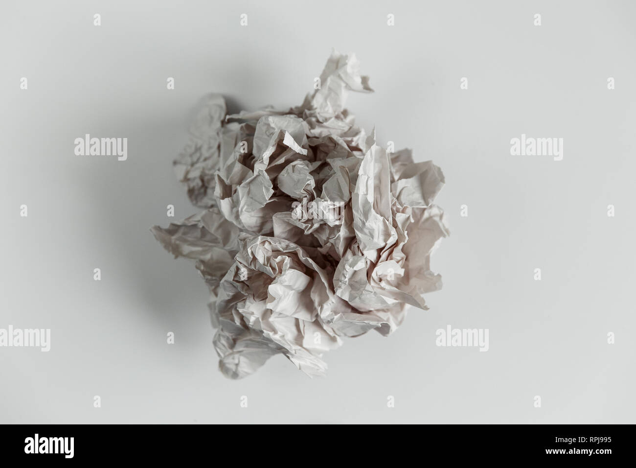Crumpled paper ball isolated on white with clipping path. Stock Photo