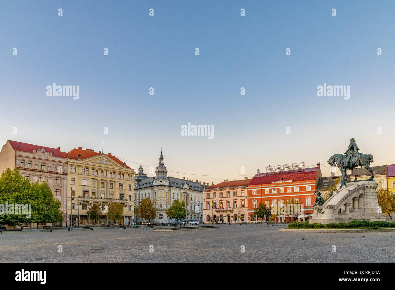 Cluj-Napoca city center. View from the Unirii Square to the Josika Palace, Rhedey Palace and New York Hotel at sunrise on a beautiful, clear sky day Stock Photo