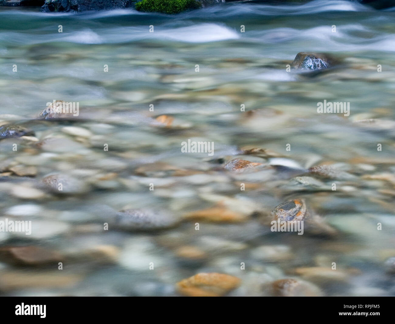 California river, slow shutter, sharp rocks and water in blurred motion ...