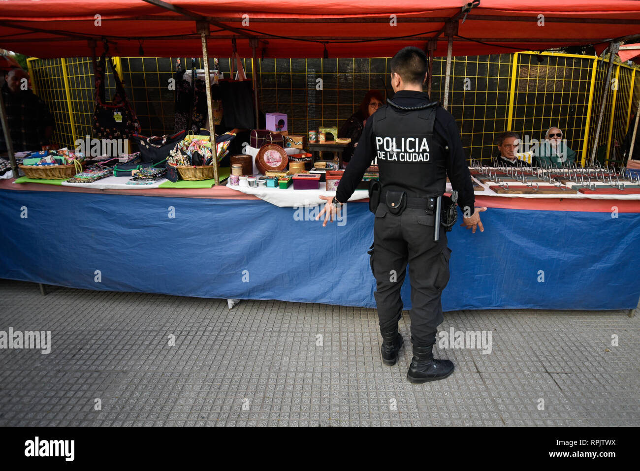 Buenos Aires, Argentina - 24 Jun, 2017: A policeman talking with seller at the souvenir shop in Palermo neighborhood. Stock Photo