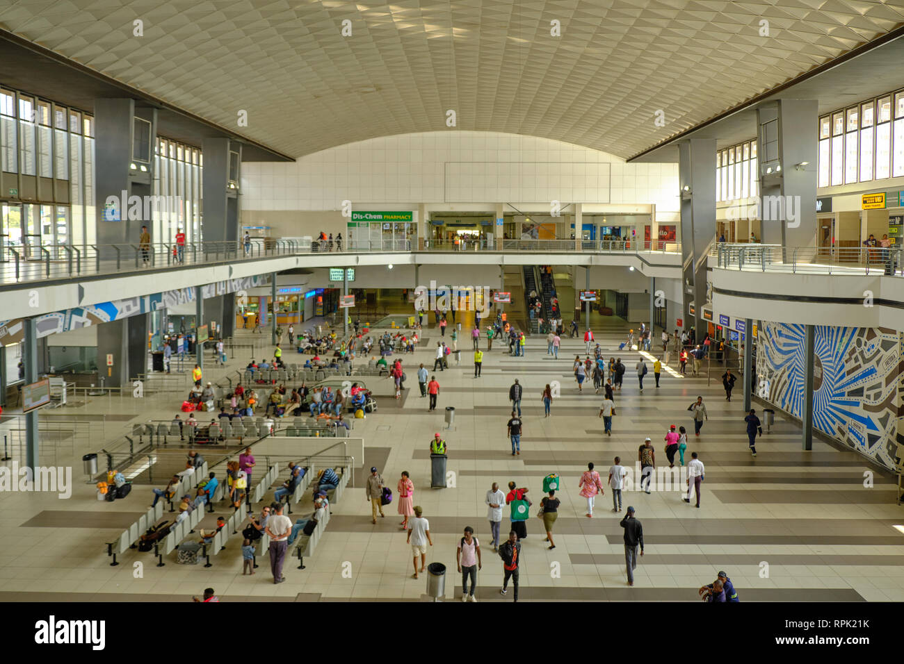 The inside of the main hall of Johannesburg train station, with people waiting their next transport, as seen from the second floor deck. Johannesburg, Stock Photo