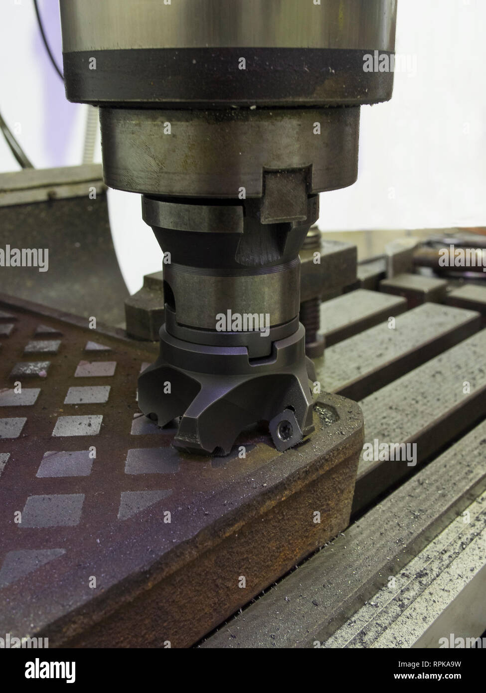 face milling tools with carbide inserts ready to work on a metal plate