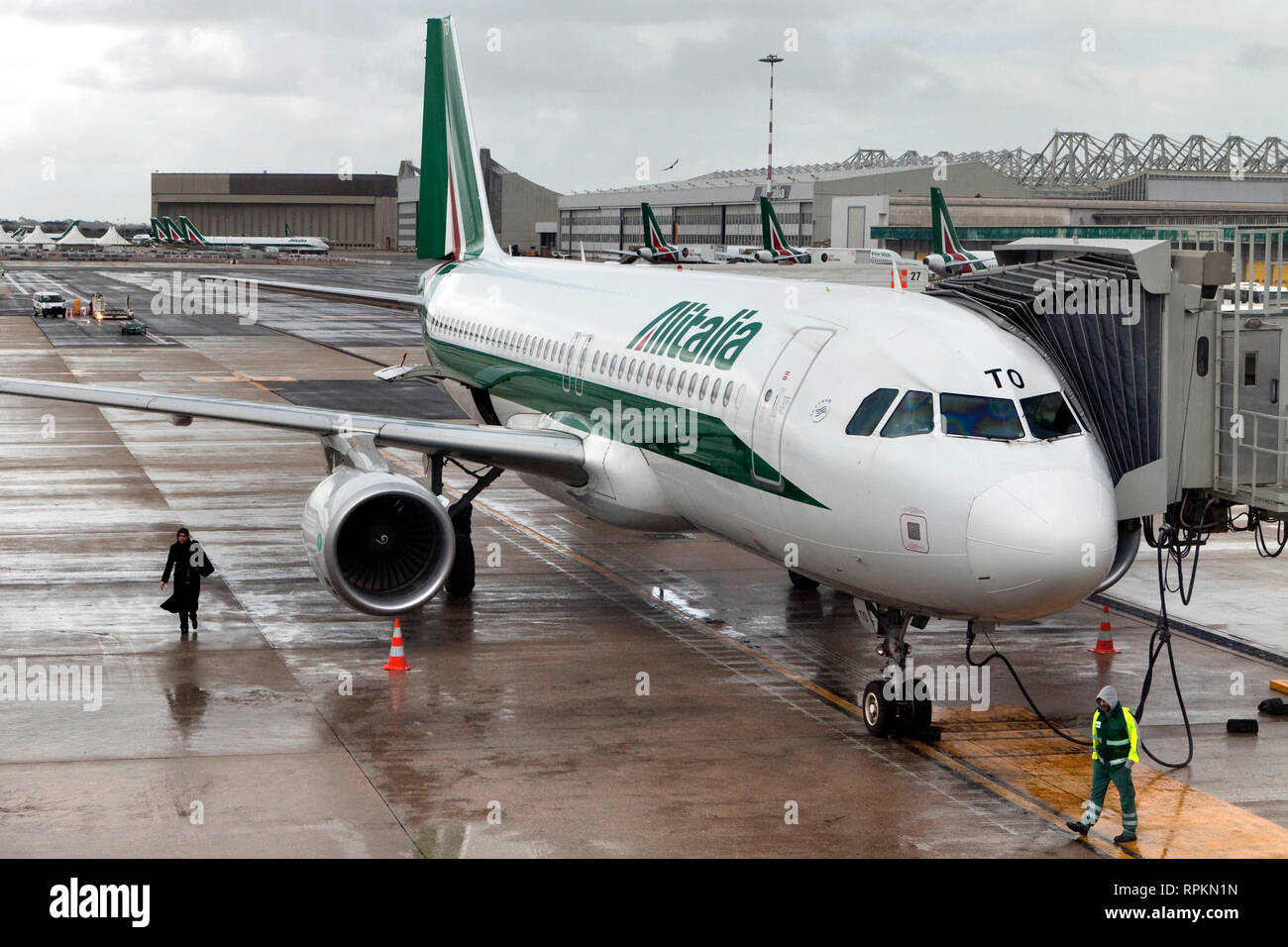 An Alitalia airplane is prepared and fueled for departure at Fiumicino airport Stock Photo