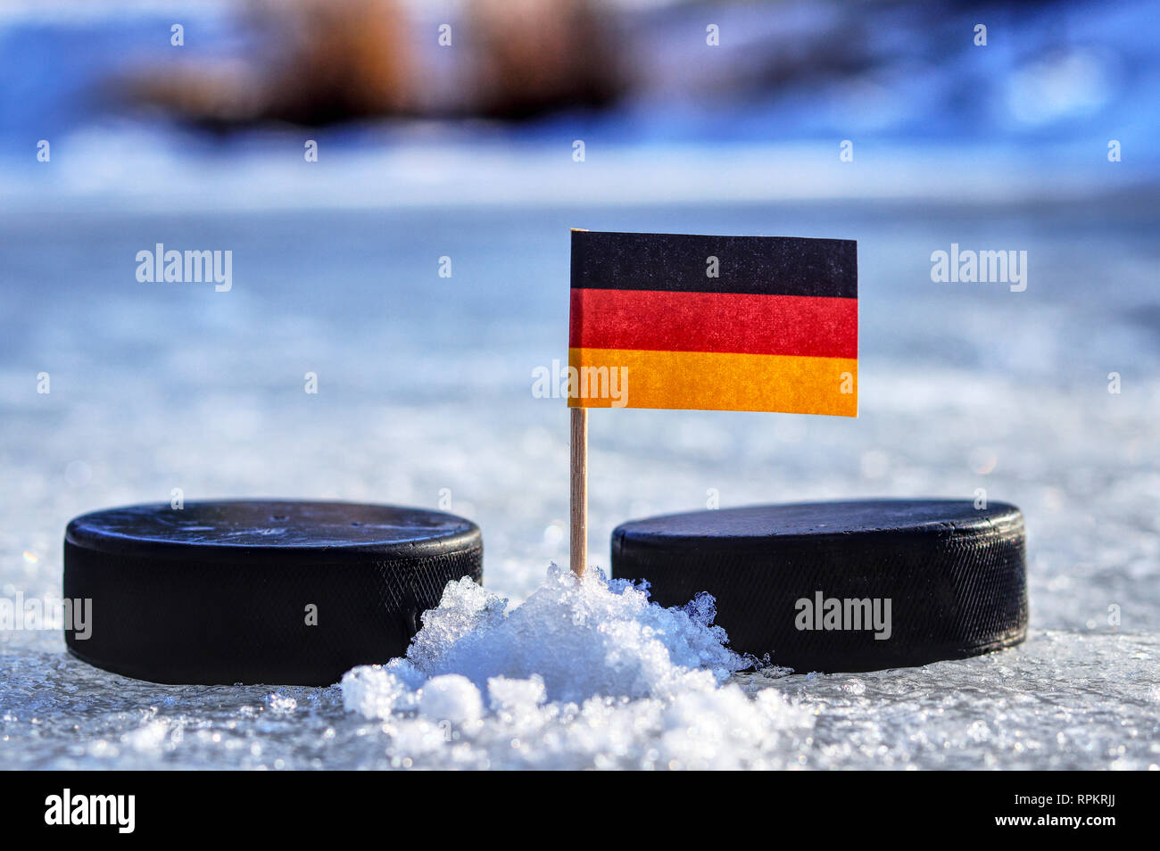 A Germany flag on toothpick between two hockey pucks.  A Germany will playing on World cup in group A. 2019 Ice Hockey World Championship in Bratislav Stock Photo