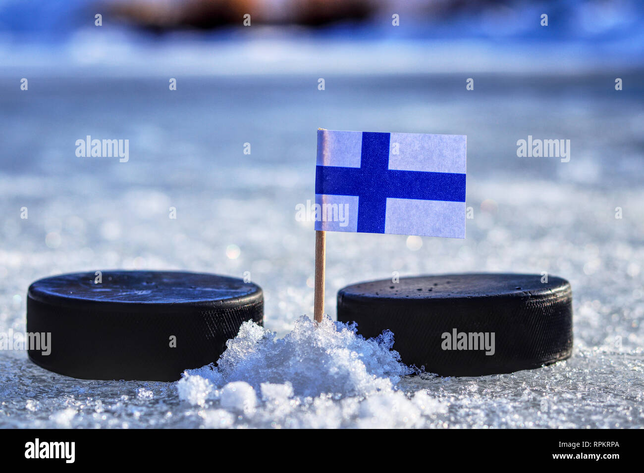 A finland flag on toothpick between two hockey pucks. A finland will playing on World cup in group A. 2019 Ice Hockey World Championship in Bratislava Stock Photo