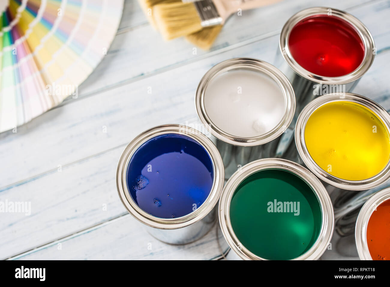 Paint cans brushes and color palette on table. Stock Photo