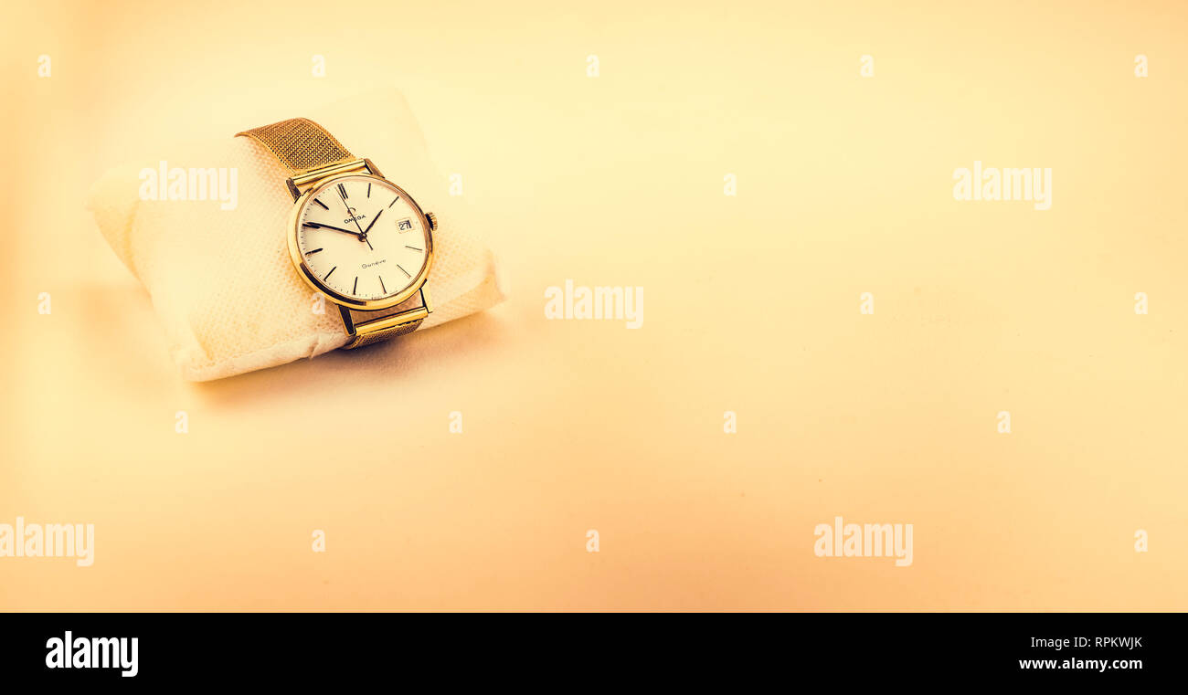 Seville, Spain - February 9 2019: Gold  Omega Geneve Automatic vintage wristwatch on colored background,  showing 13:50:59 on the 27st Stock Photo