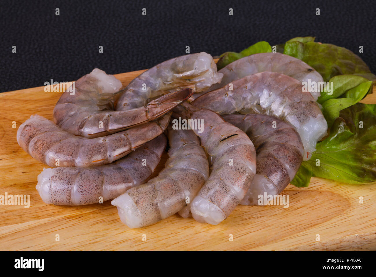 Raw king prawns ready for cooking served salad leaves Stock Photo Alamy