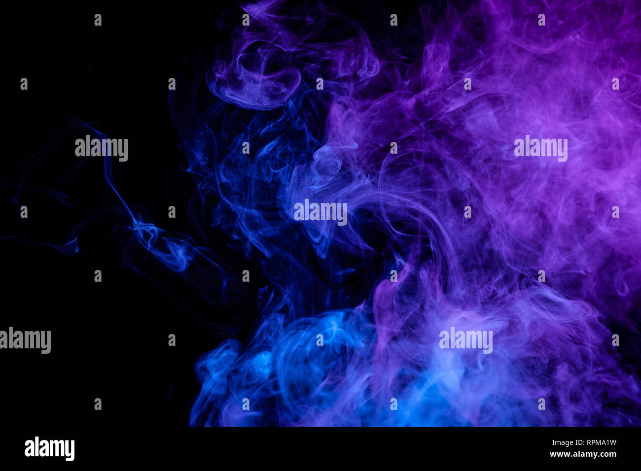 Blue and purple bomb smoke on black isolated background Stock Photo - Alamy