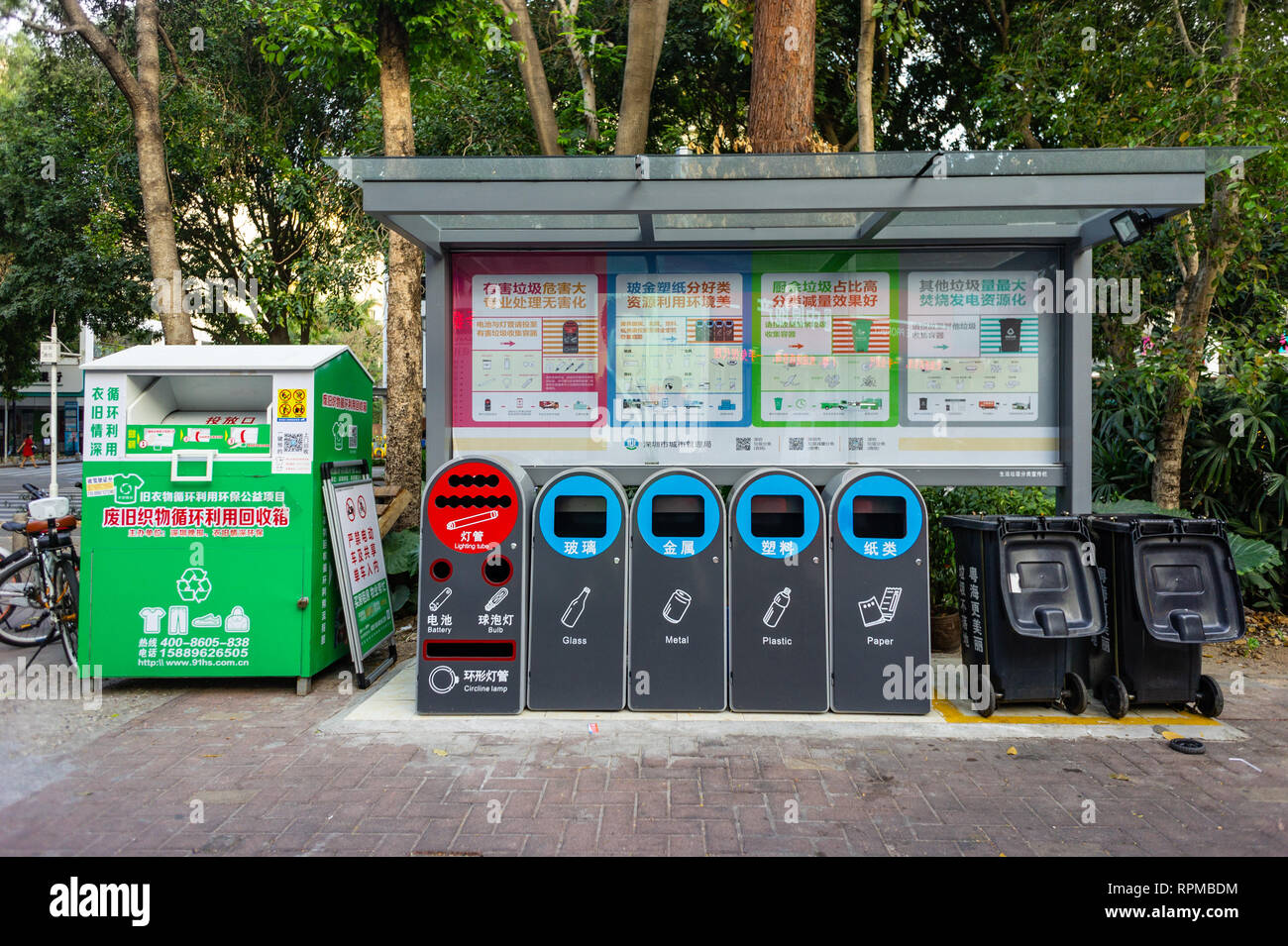 Recycling point with separate bins for clothes and lightbulb recycle in