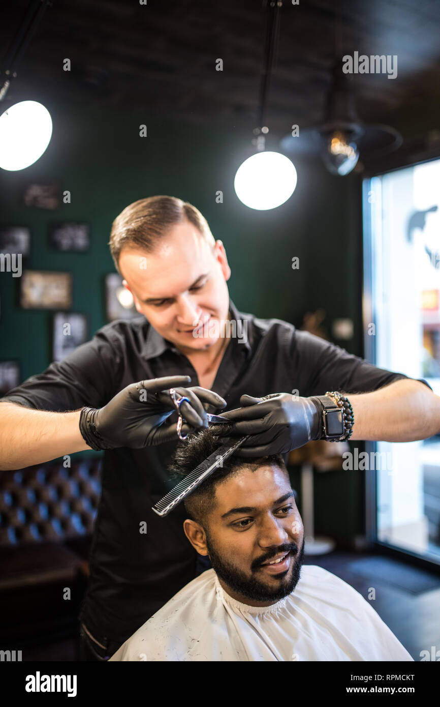 Young Handsome Guy Cuts Hair Man Cuts Hair In Barbershop Stock