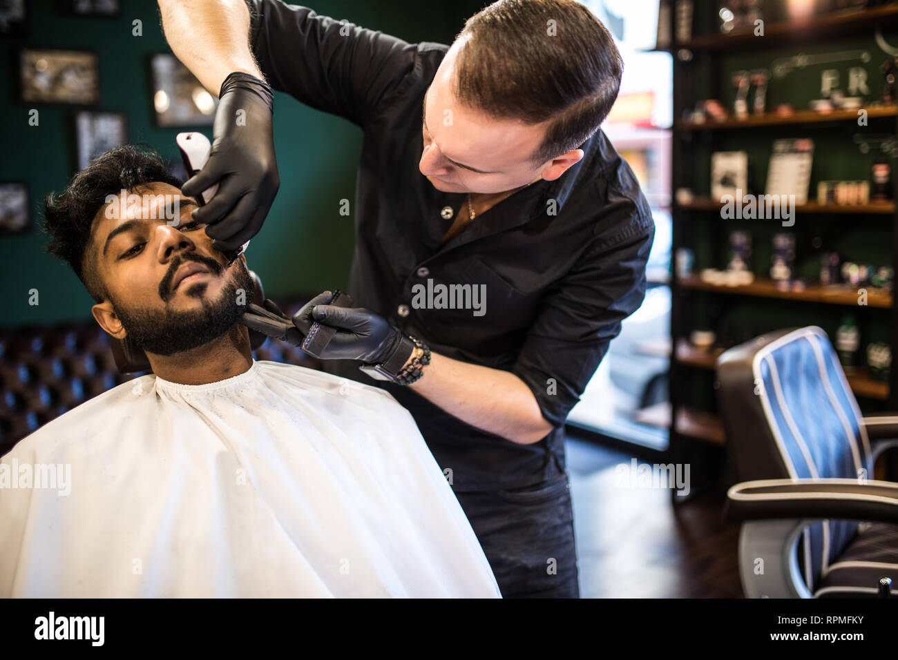 Grooming Of Real Man Side View Of Young Bearded Man Getting Beard