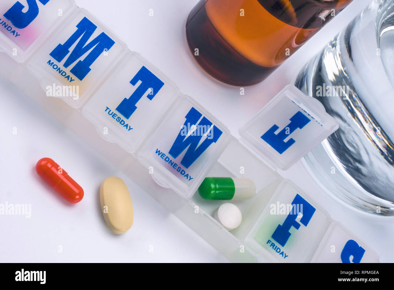 weekly pillbox with medication, conceptual image, horizontal composition Stock Photo