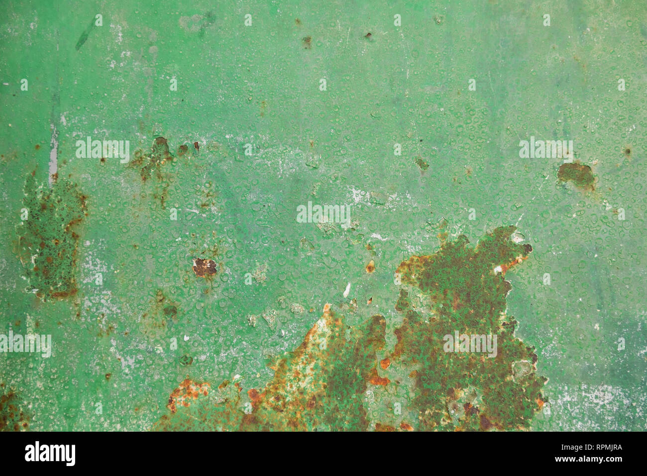 Multicolor background: rusty metal surface with green paint that cracks and cracks Stock Photo