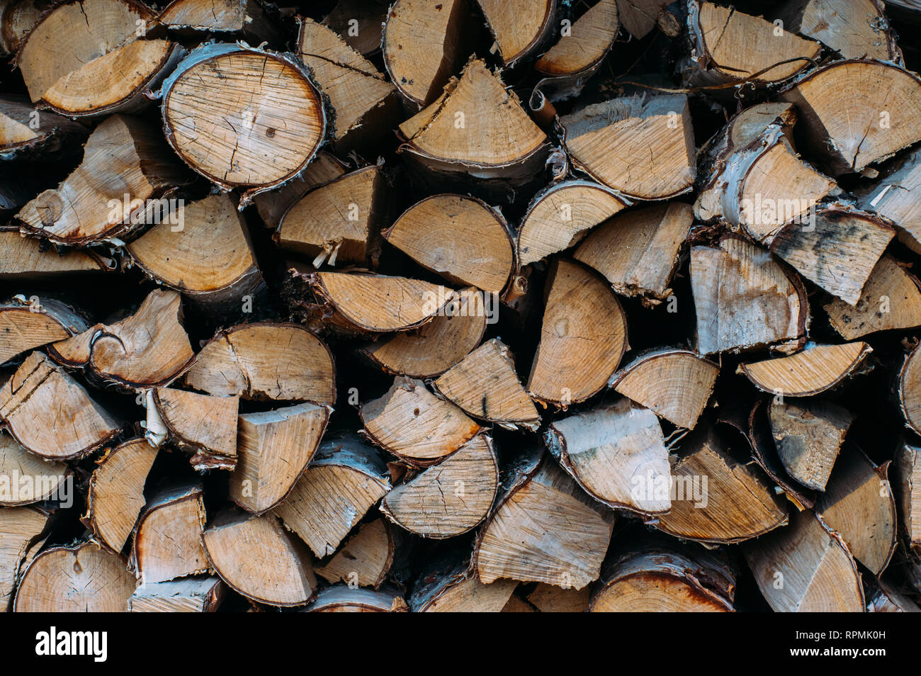 Pile of chopped fire wood prepared for winter, stack of wood, background texture Stock Photo