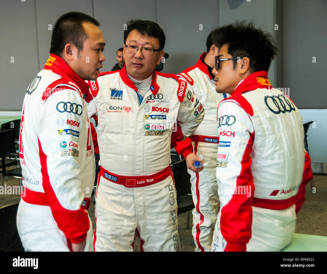 Formula One Racers Huddle Hong Kong superstar Aaron Kwok in a huddle with other racers at the ...