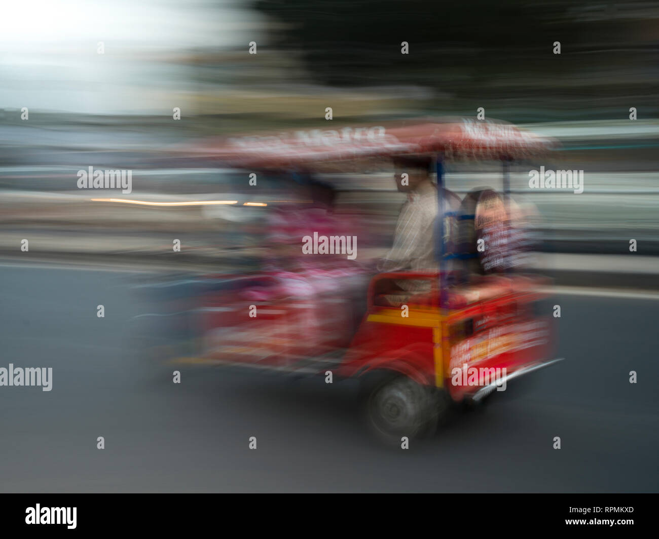 Blurred motion view of a battery operated rickshaw, Amer Road, Jaipur ...
