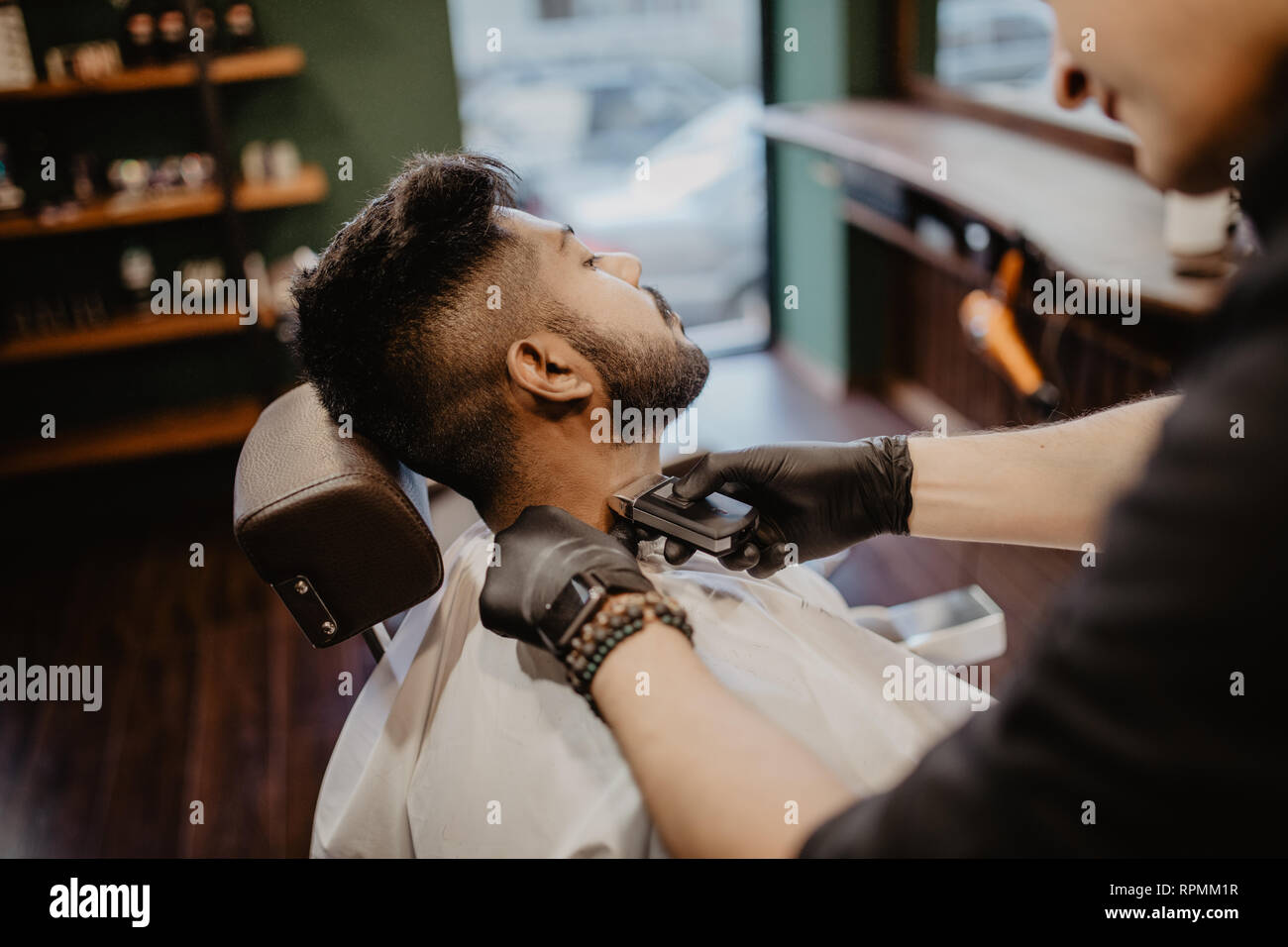 Client during beard and moustache grooming in barber shop Stock Photo