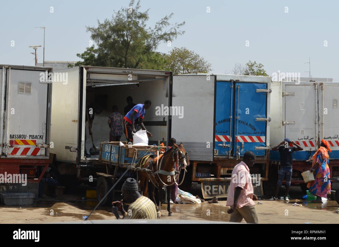 Trucks at the parking lot of Mbour fish market Stock Photo Alamy