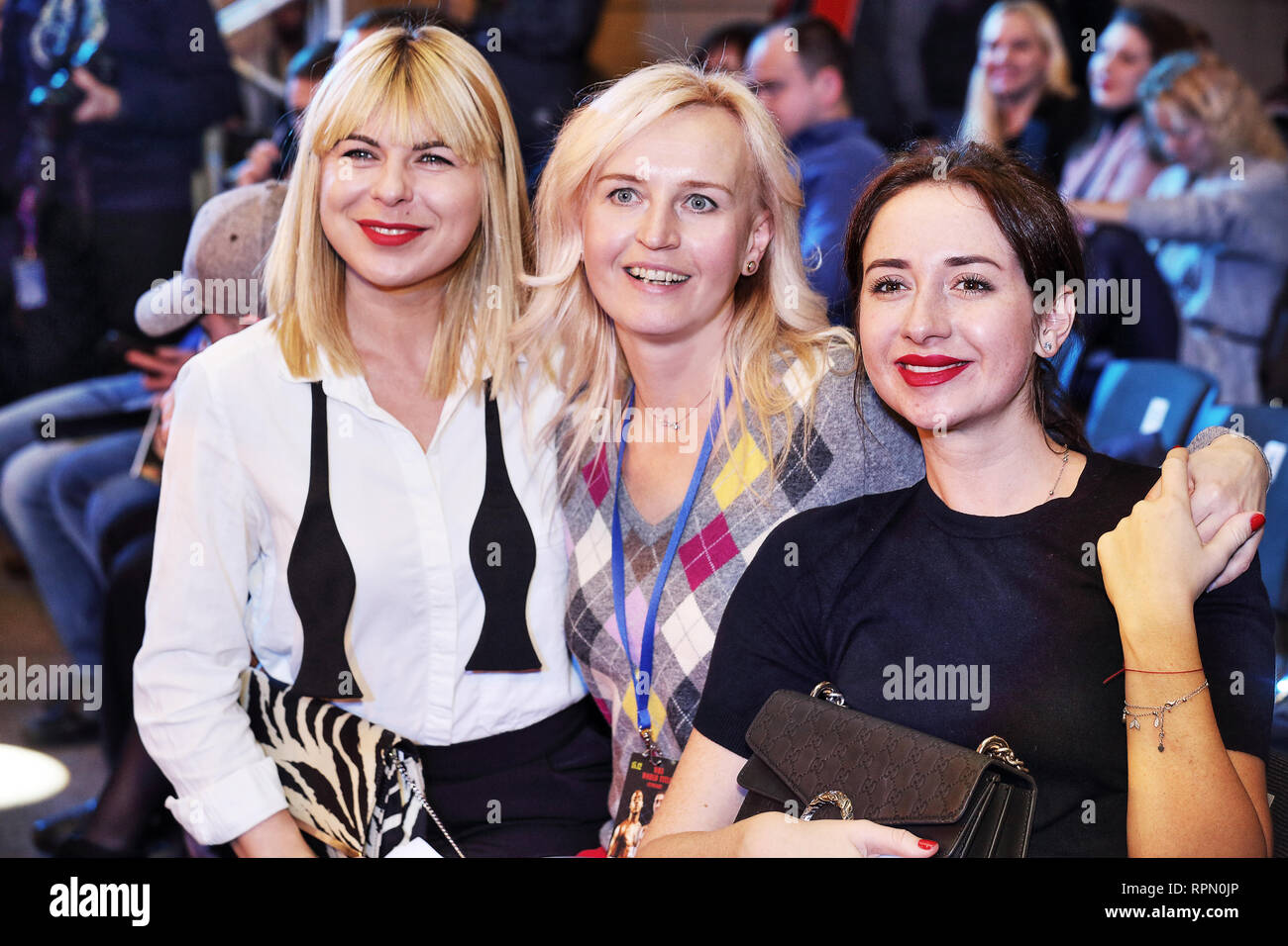 Ukraine's only Female Boxing World Champion, good looking blond Alina Shaternikova (central) poses with her two girl friends at boxing event in Kiev. Stock Photo