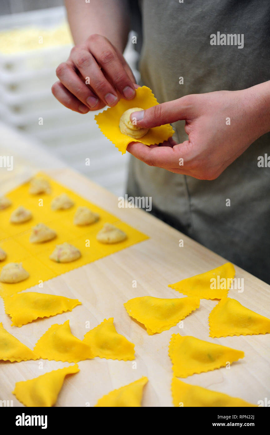 Close-up of woman's hand making tortellini in Bologna, Italy Stock Photo