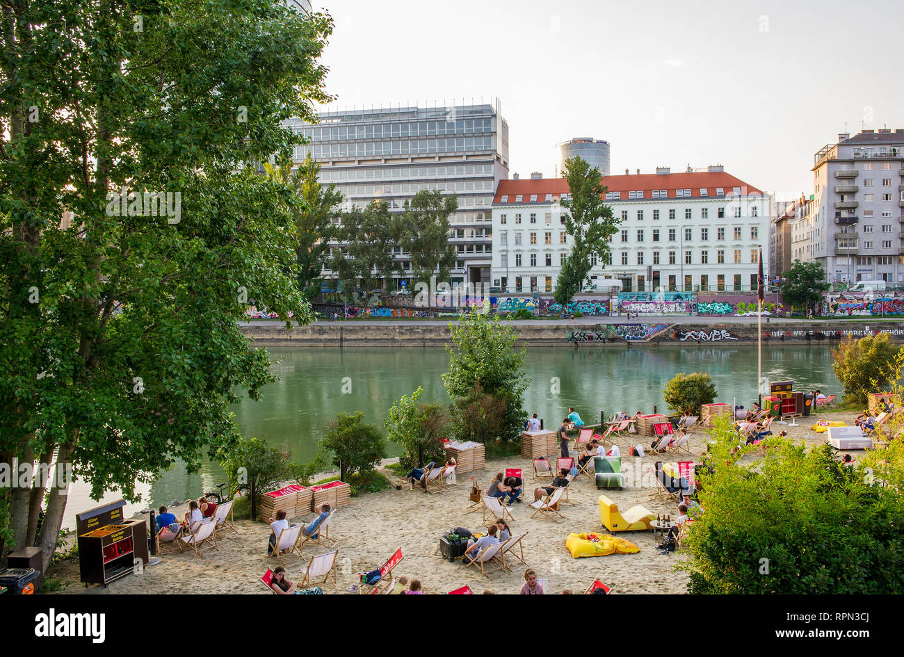 People chilling at Strandbar Herrmann, Vienna's urban beach, open from mid-April to early October, along the Danube canal (Donaukanal) Stock Photo
