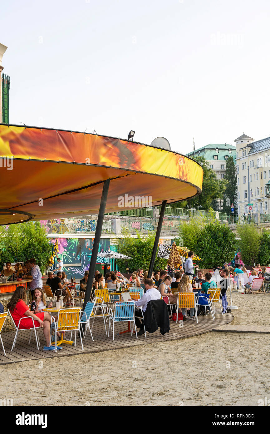 People chilling at Strandbar Herrmann, Vienna's urban beach, open from mid-April to early October, along the Danube canal (Donaukanal) Stock Photo