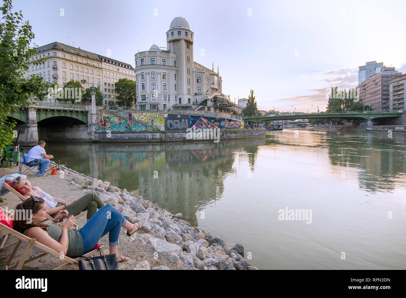 People chilling at Strandbar Herrmann, Vienna's urban beach, open from mid-April to early October, along the Danube canal (Donaukanal) Stock Photo