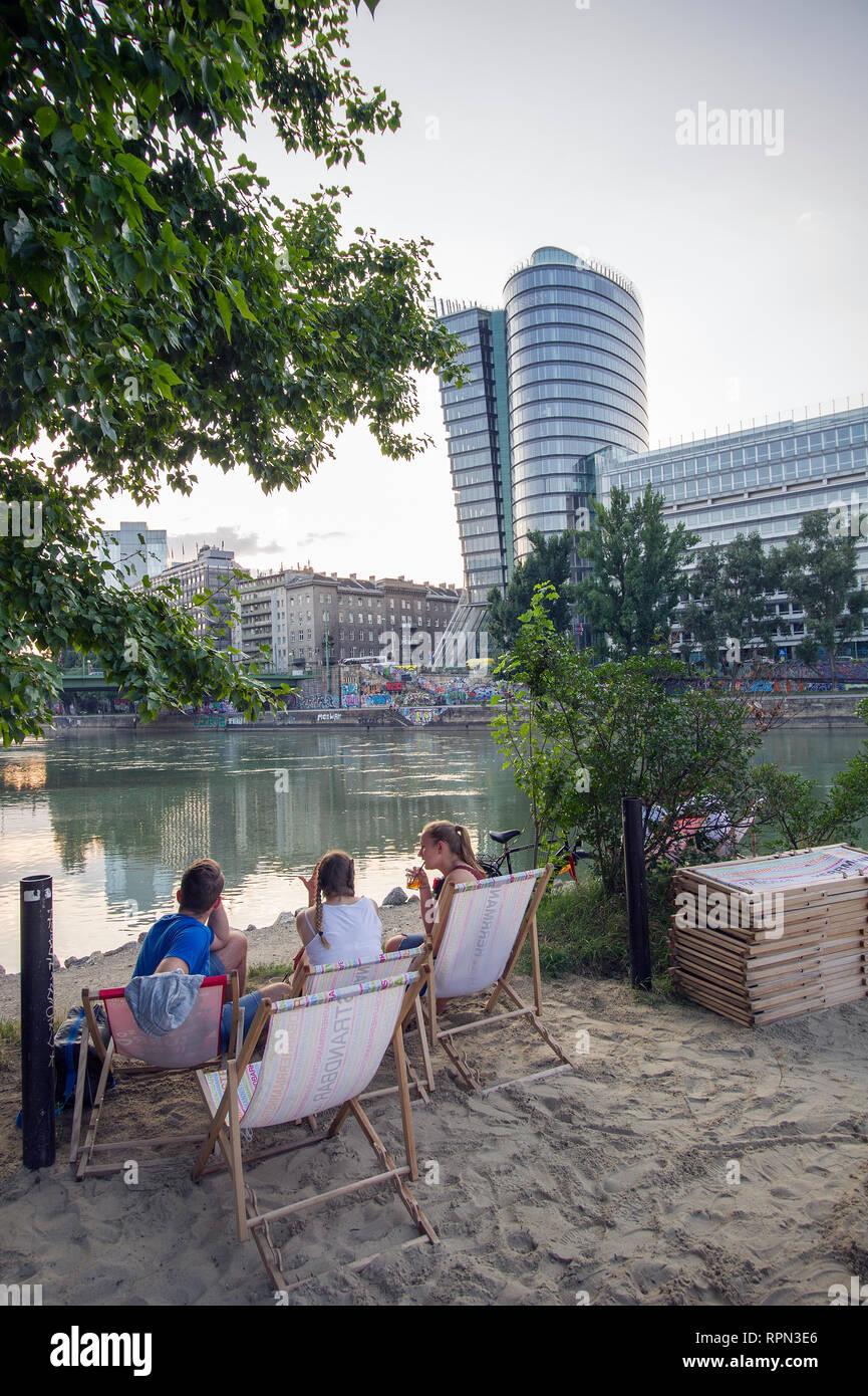 People chilling at Strandbar Herrmann, Vienna's urban beach, open from mid-April to early October, along the Danube canal (Donaukanal). Stock Photo
