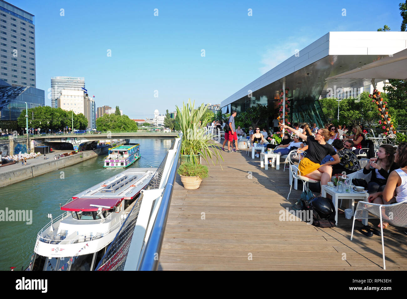 People chilling outdoors in one of the cafes along the Donaukanal , Vienna, Austria Stock Photo