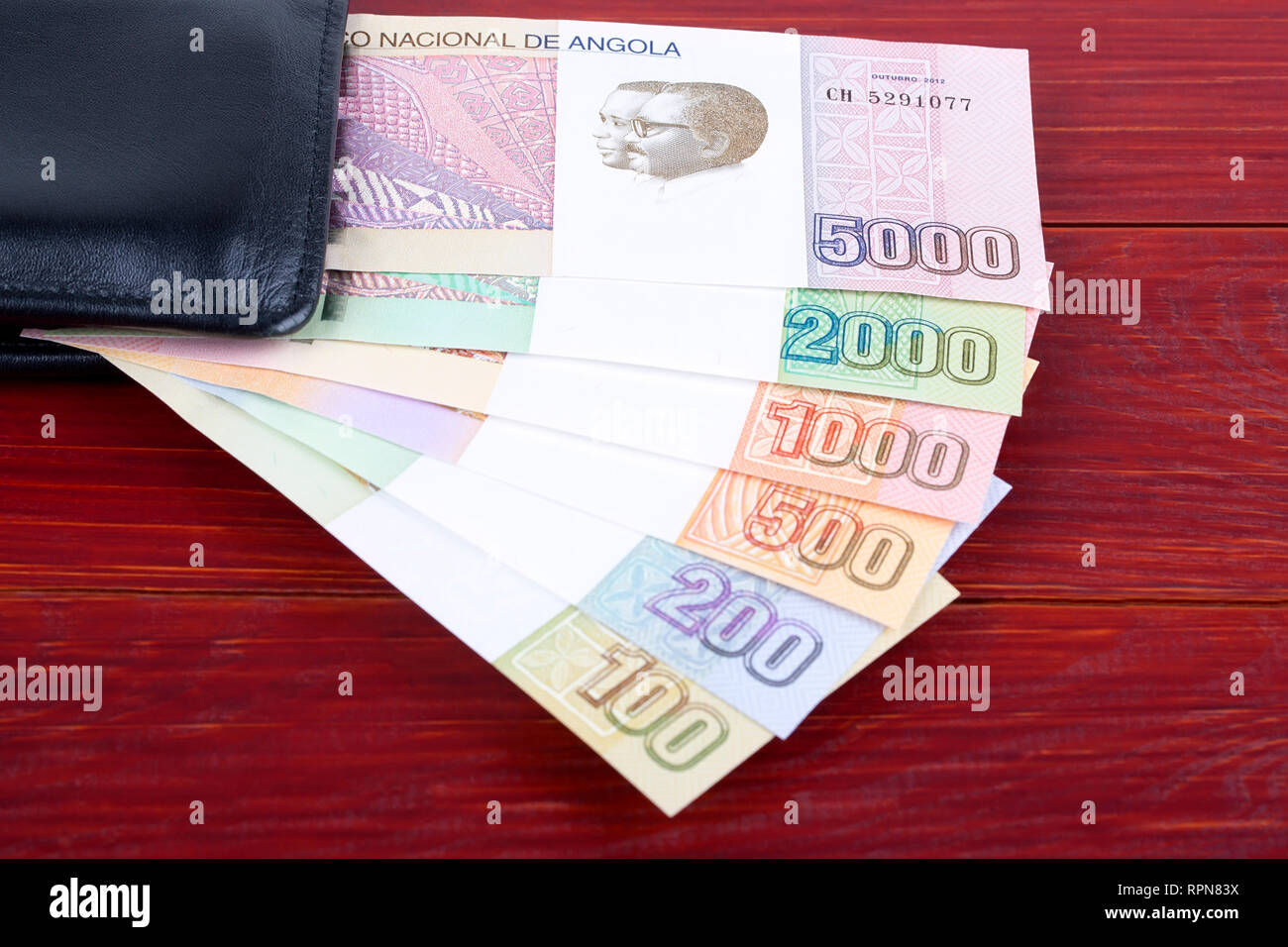 Angolan money in the black wallet Stock Photo