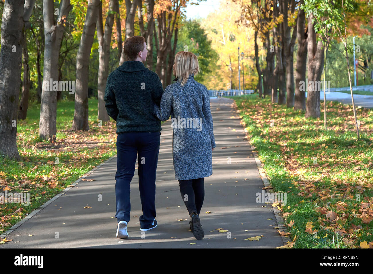 Romantic Couple Relaxing In Autumn Park Cuddling Enjoying